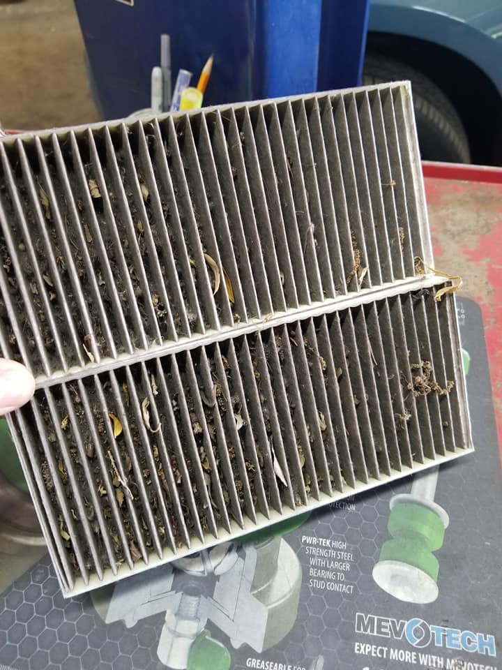 A used vehicle filter being inspected at the workbench